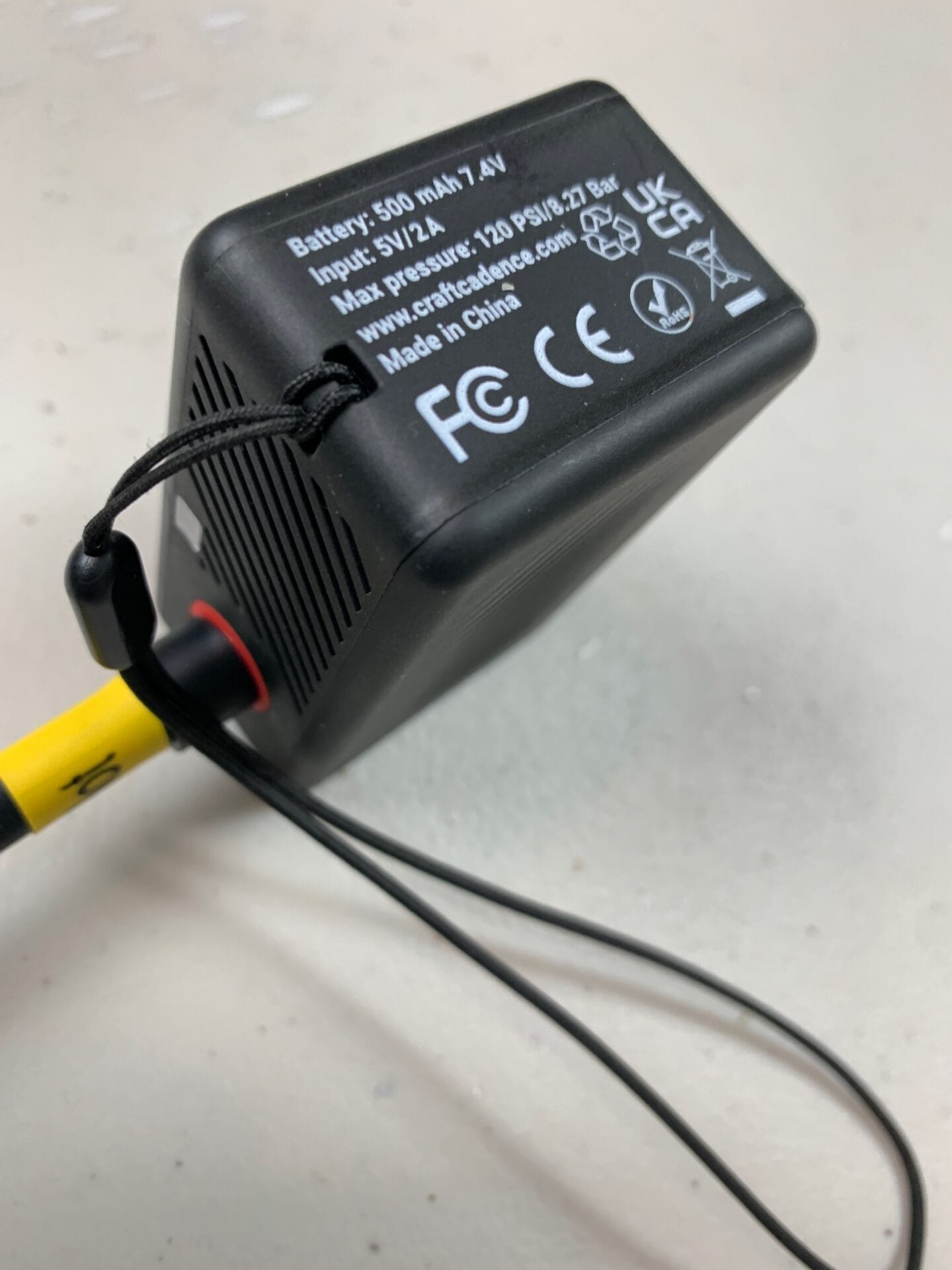 Side of e-mini pump with tether on it.