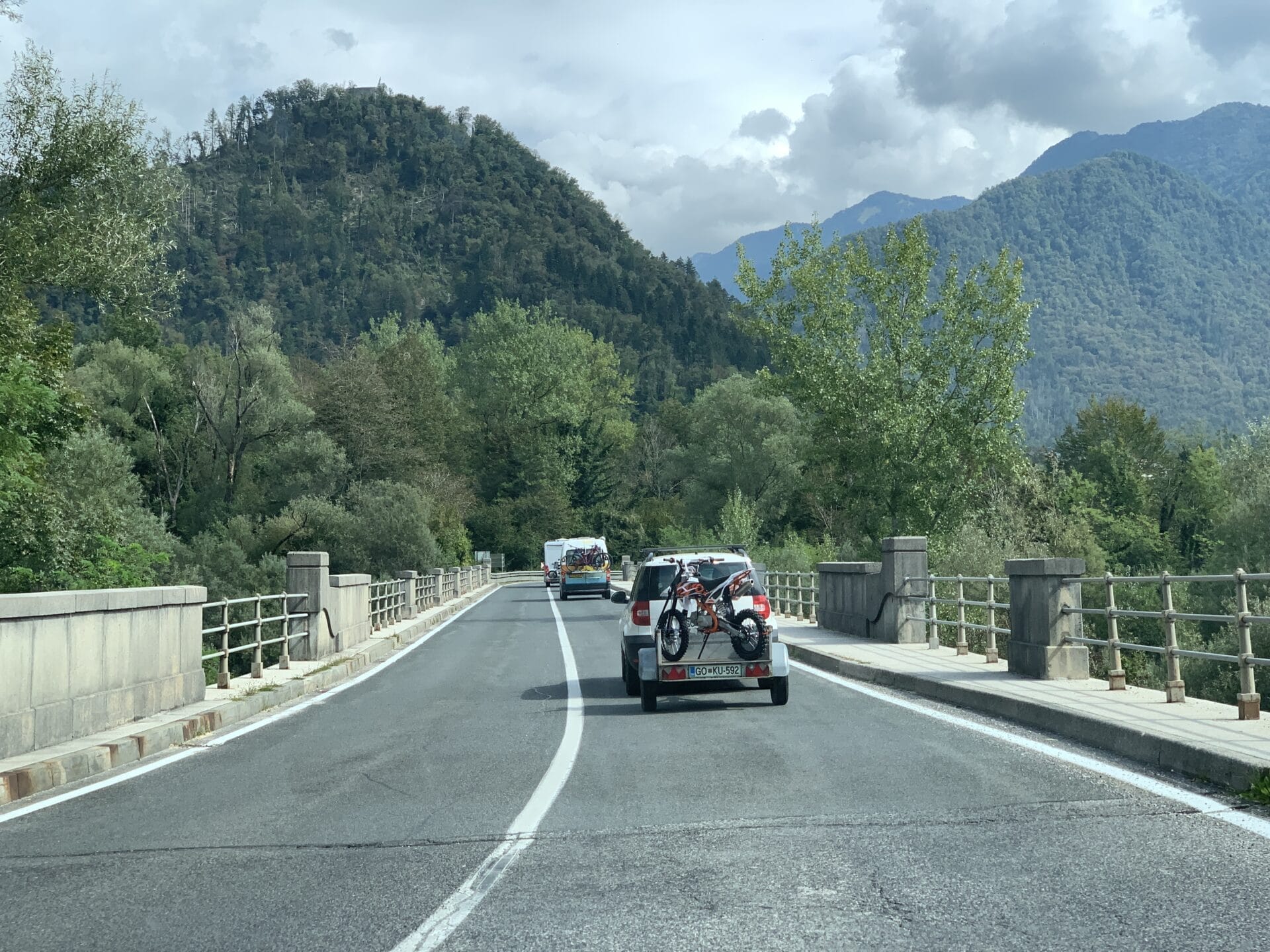 down the road a car pulling a trailer