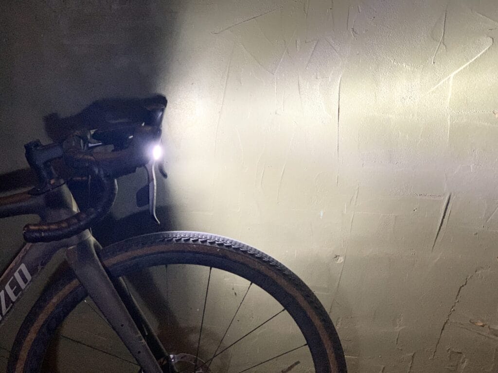 Profile view of light on bike next to a wall.