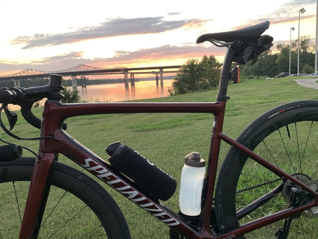 sunset picture of road bike near the river with silca seat roll installed