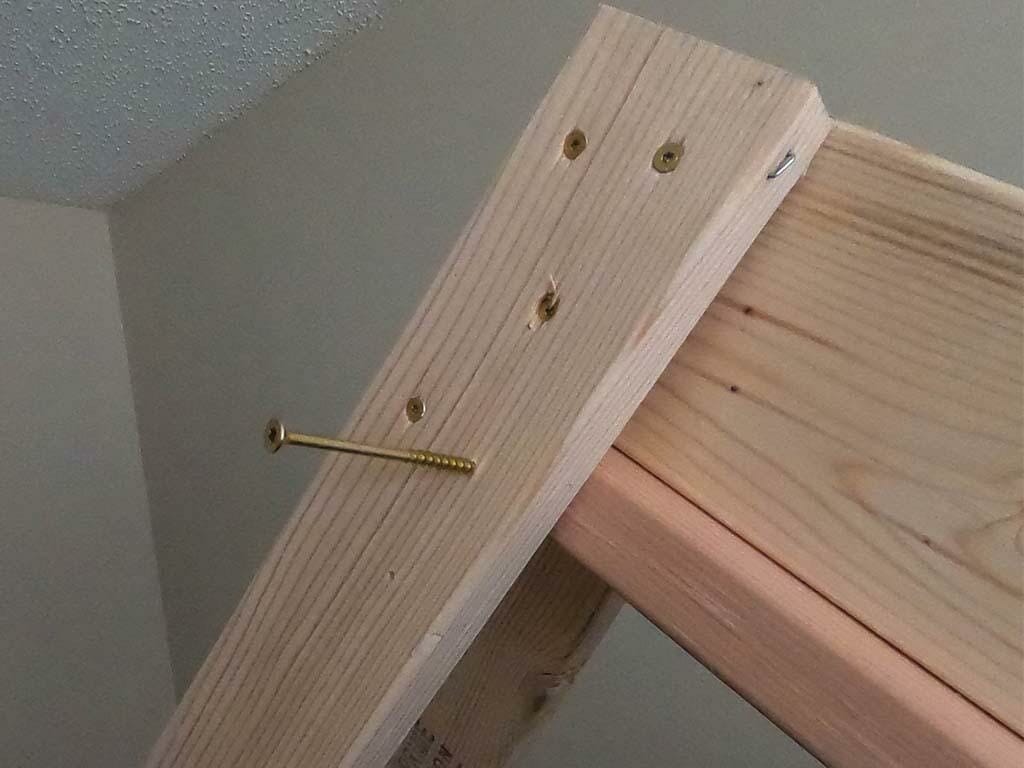 close up of the screws into the legs and beam